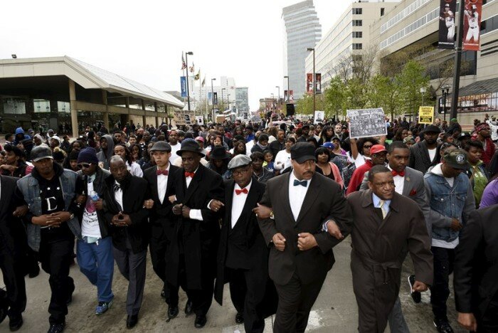demonstrators_march_to_city_hall_to_protest_against_the_death_of_freddie_gray_in_police_custody_NQXF